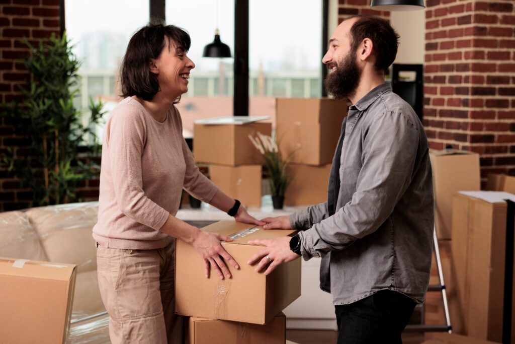 A couple is happily packing for their move.