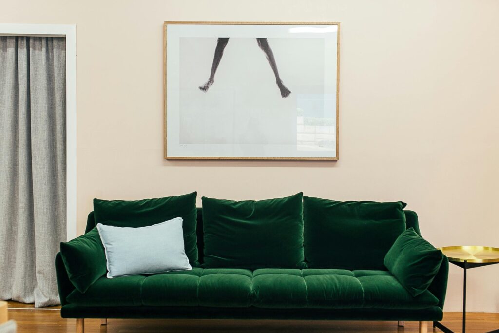 A green velvet sofa in a modern flat