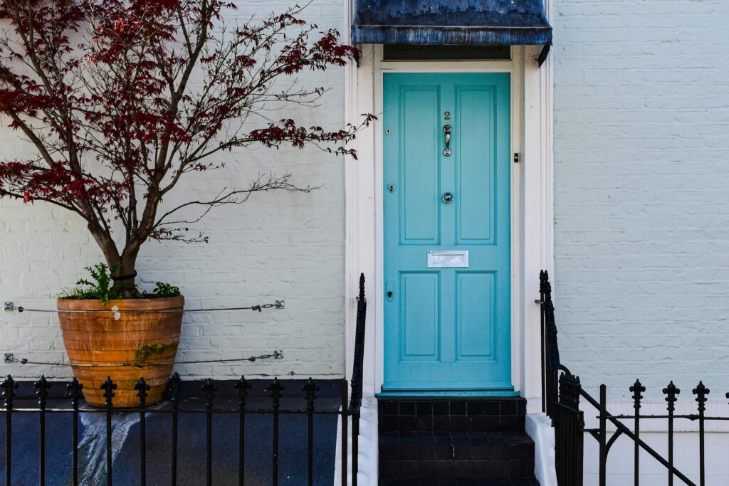 In front of a traditional British townhouse in the concept of affordable housing options in Coulsdon.