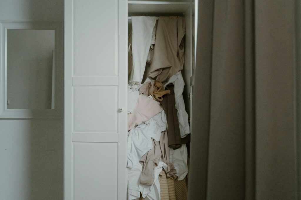 Cropped image of a messy closet full of clothes