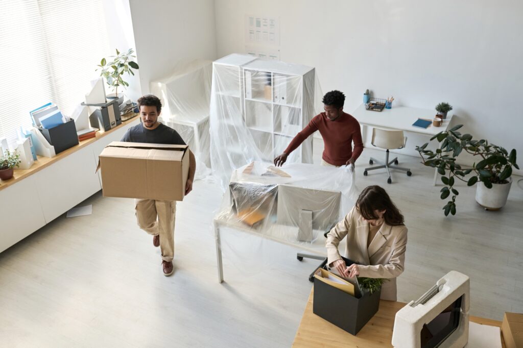 High-angle shot of employees unpacking after the move