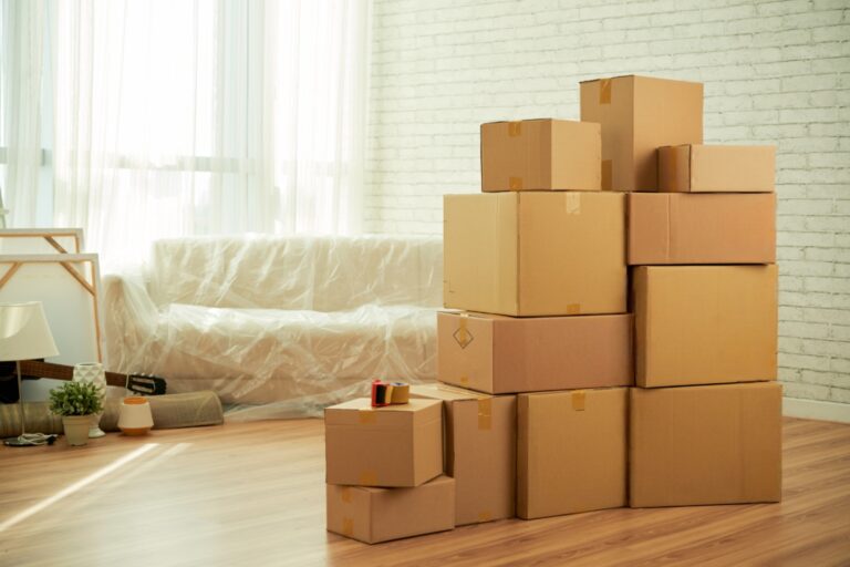 Stacks of boxes in the living room in the concept of 'Coulsdon Removals Cost'.